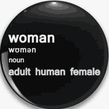 a black button that says ' woman ' on it