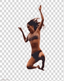 a woman in a bikini is jumping in the air with her arms outstretched .