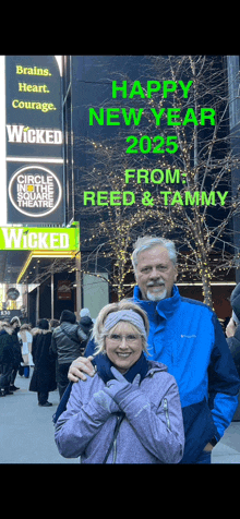 a man and woman standing in front of a sign that says happy new year 2025