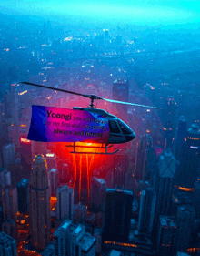 a helicopter flies over a city with a banner that says yoongi