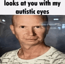 a bald man with autistic eyes looks at you with his eyes .