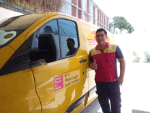 a man giving a thumbs up next to a yellow van that says " great place to work "