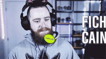 a man with a beard is wearing headphones and a cat ear hat .