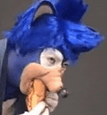 a close up of a person wearing a sonic the hedgehog costume eating a sandwich .