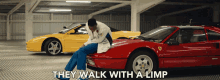 a man sits on the hood of a red sports car with the words " they walk with a limp " above him