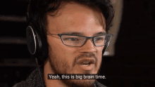 a man wearing glasses and headphones is talking about a big brain time .