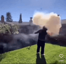 a man is standing in front of a house with smoke coming out of his head .