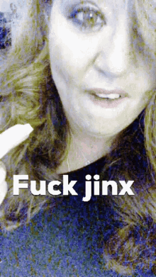 a close up of a woman 's face with the words " fuck jinx " on the bottom