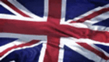 a close up of the british flag waving in the wind .