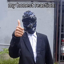 a man in a suit giving a thumbs up with the words my honest reaction