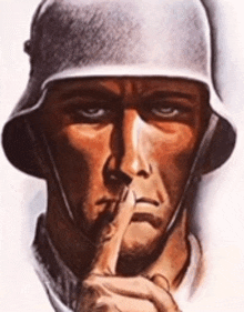 a man wearing a helmet holds his finger to his lips