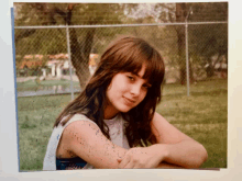 a picture of a young girl with a white shirt on