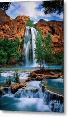 a waterfall is surrounded by trees and rocks in the middle of a lush green forest