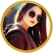 a picture of a woman wearing sunglasses and a sweater in a gold frame