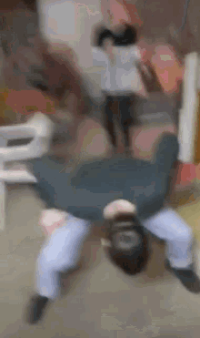 a man is laying on his back on the floor in a room .