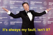 a man in a tuxedo poses in front of a breakthrough prize wall