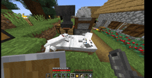 a screenshot of a minecraft game shows a white cat laying on a bed