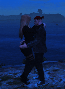 a man and a woman are hugging in front of a body of water at night