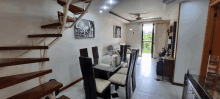 a dining room with a staircase leading to the second floor