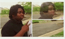 a man with dreadlocks is standing in a parking lot and pointing at something .