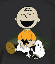 charlie brown is sitting on snoopy 's back and laughing .