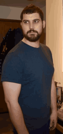 a man with a beard wearing a blue t-shirt