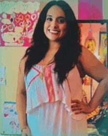 a woman stands in front of a hello kitty poster on the wall