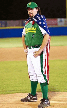 a man wearing a green jersey that says ' castros ' on it stands on a baseball field