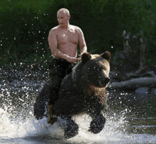 a shirtless man is riding on the back of a large brown bear in the water .