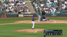 a baseball game is being played in front of a crowd and a sign that says " your spring training home "