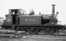 a black and white photo of a minor train on the tracks