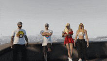 a group of people standing on a rooftop with one wearing a t-shirt with a monkey on it