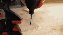 a person is drilling a screw into a piece of wood with a drill that says ez on it