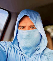 a man wearing a blue hoodie with a face mask