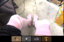 a person wearing pink and white striped socks sitting on the floor