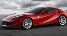 a red ferrari sports car is parked on the street