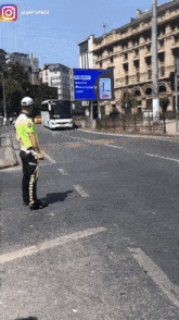 a police officer stands in the middle of a street in front of a billboard that says ' istanbul '