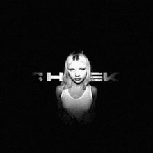 a woman in a tank top is standing in front of a black background with the letters " theek " on it