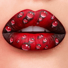 a close up of a woman 's lips with water drops on them