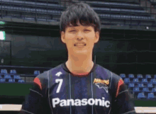 a young man wearing a panasonic jersey with the number 7 on it