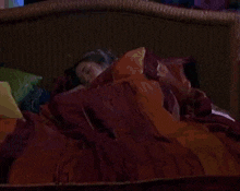 a person is sitting on a couch with a green light coming out of their head .