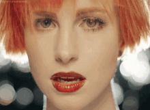 a close up of a woman 's face with a hashtag that says theintoparamore