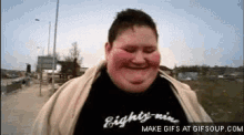 a fat man wearing a black shirt that says eighty-nine