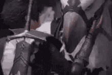a knight is riding a horse and holding a sword .
