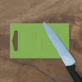 a person is cutting something with a knife on a cutting board