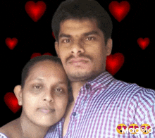 a man and a woman are posing for a picture with hearts behind them