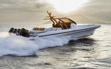 a white boat with a mercury outboard engine is going through the water