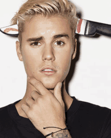 justin bieber has a knife stuck to his head