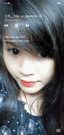 a girl 's face is displayed on a phone screen and the date is june 27