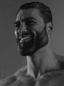 a man with a beard is smiling in this black and white photo